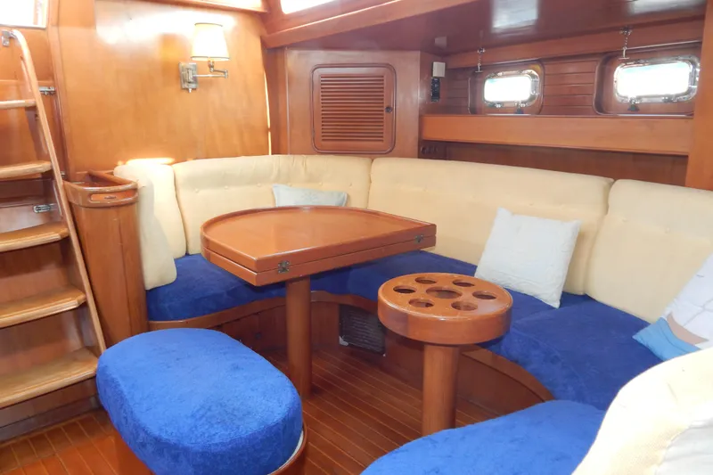  Yacht Photos Pics Interior of 1992 Tayana 55 yacht with cozy seating and wooden table.
