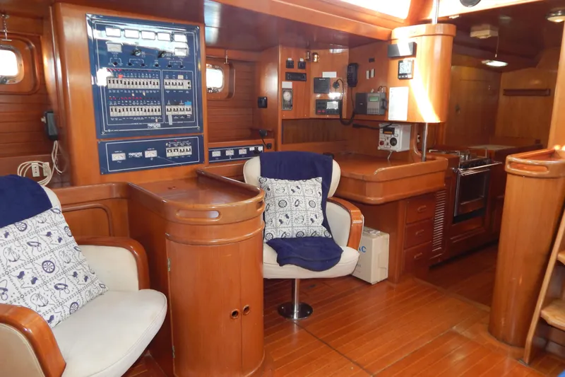  Yacht Photos Pics Interior of 1992 Tayana 55 yacht with wooden paneling and navigation equipment.