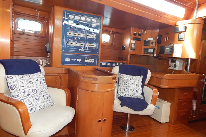  Yacht Photos Pics Interior of 1992 Tayana 55 yacht with wooden paneling and control panels.