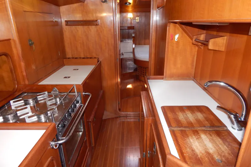  Yacht Photos Pics Interior of 1992 Tayana 55 yacht featuring a wooden galley with stove and sink.