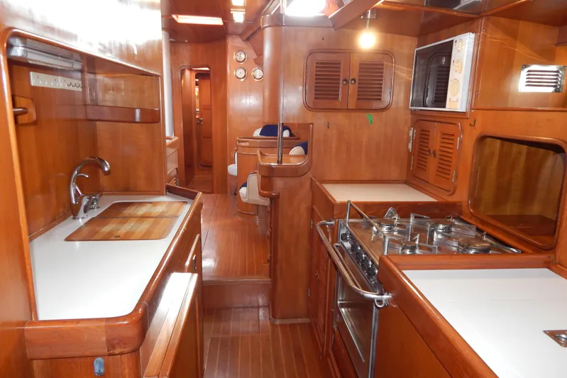  Yacht Photos Pics Interior of 1992 Tayana 55 yacht featuring a wooden galley with stove and sink.