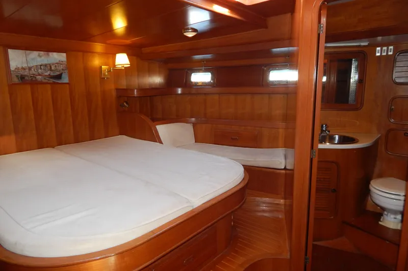  Yacht Photos Pics Luxurious wooden interior of 1992 Tayana 55 yacht cabin with bed and bathroom.
