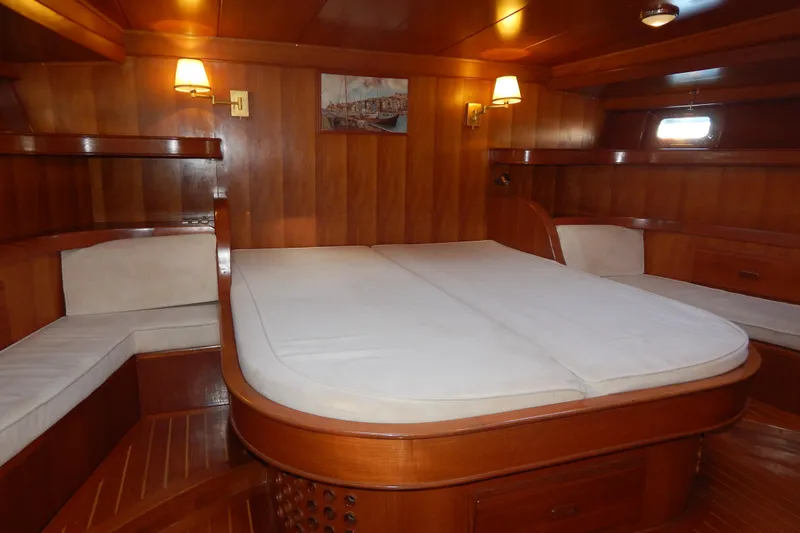  Yacht Photos Pics Luxurious wooden cabin interior of 1992 Tayana 55 yacht with cozy bed and seating.