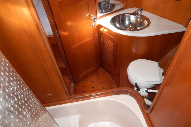  Yacht Photos Pics Bathroom interior of 1992 Tayana 55 yacht with wooden finish and compact design.