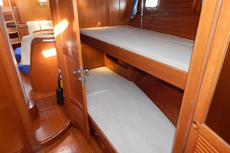 Yacht Photos Pics Interior of 1992 Tayana 55 yacht with wooden bunk beds and cozy cabin.
