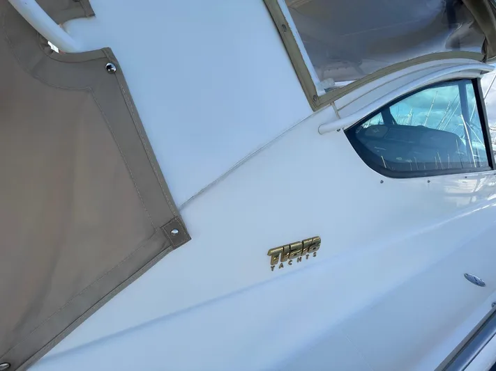  Yacht Photos Pics 2007 Tiara Yachts 3800 Open, side view with logo and window detail.