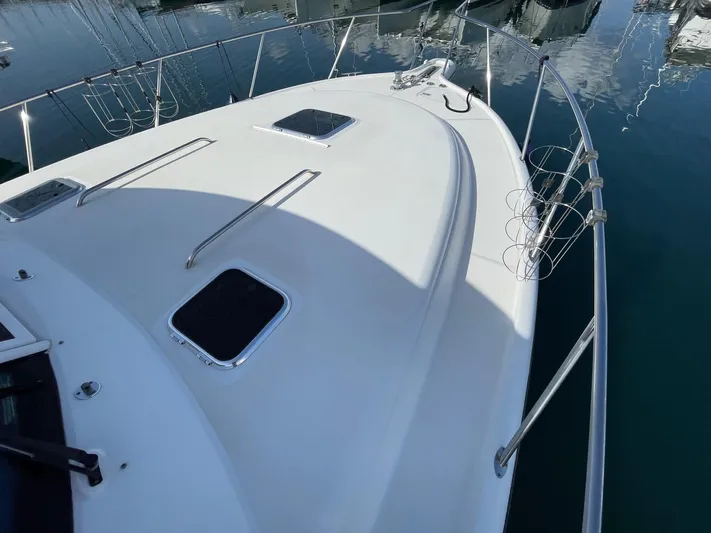  Yacht Photos Pics 2007 Tiara Yachts 3800 Open boat deck with railing and hatches in marina.