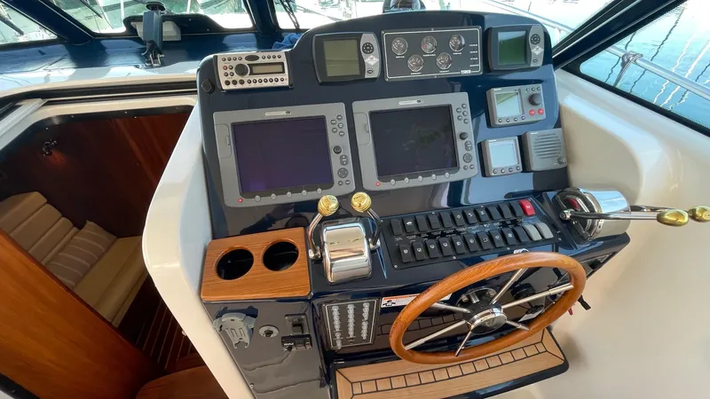  Yacht Photos Pics 2007 Tiara Yachts 3800 Open helm with navigation controls and wooden steering wheel.