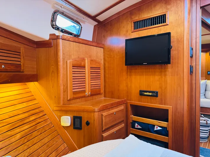 On Holidays - Reserved Yacht Photos Pics 2018 Sabre 42 Salon Express interior with wood paneling, TV, and storage compartments.