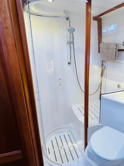 On Holidays - Reserved Yacht Photos Pics 2018 Sabre 42 Salon Express bathroom with shower and toilet, featuring wooden accents.