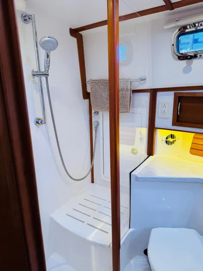 On Holidays - Reserved Yacht Photos Pics 2018 Sabre 42 Salon Express bathroom with shower, wooden accents, and modern fixtures.