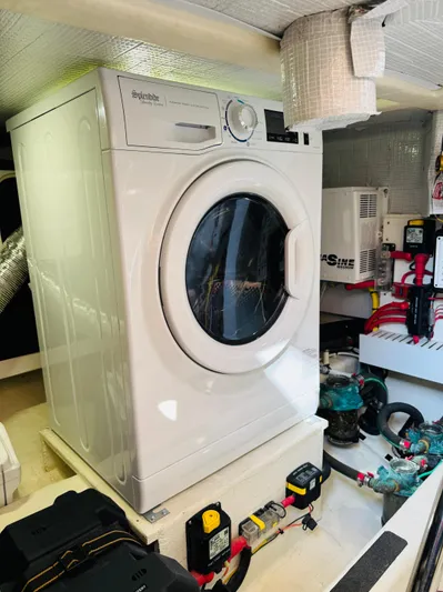 On Holidays - Reserved Yacht Photos Pics Laundry area inside 2018 Sabre 42 Salon Express yacht, featuring a washing machine.