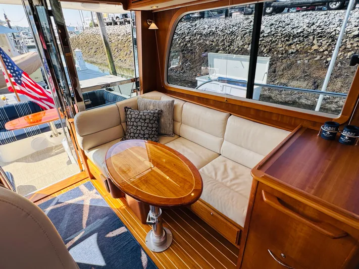 On Holidays - Reserved Yacht Photos Pics Interior of 2018 Sabre 42 Salon Express yacht with elegant seating and wooden table.