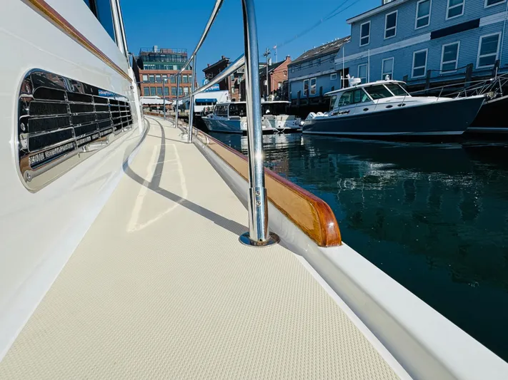 On Holidays - Reserved Yacht Photos Pics 2018 Sabre 42 Salon Express yacht docked in a marina, showcasing sleek design and waterfront buildings.