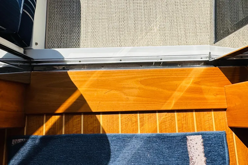 On Holidays - Reserved Yacht Photos Pics Interior view of 2018 Sabre 42 Salon Express with wooden flooring and blue rug.