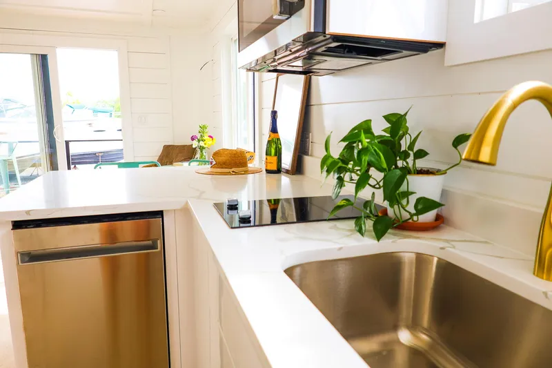  Yacht Photos Pics Modern kitchen in 2025 Hank's 40 Houseboat with sleek appliances and greenery.