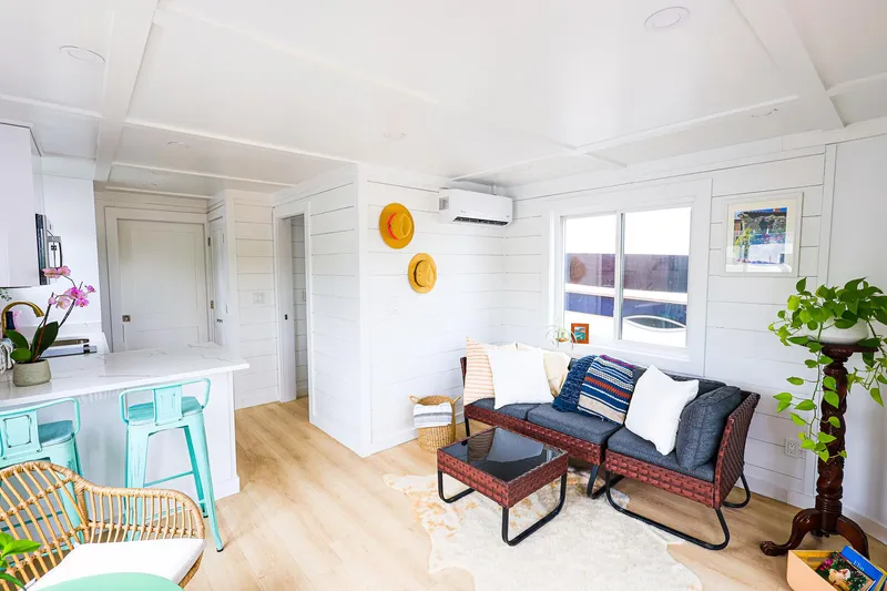  Yacht Photos Pics Modern interior of Hank's 40 Houseboat, 2025 model, featuring cozy seating and bright decor.