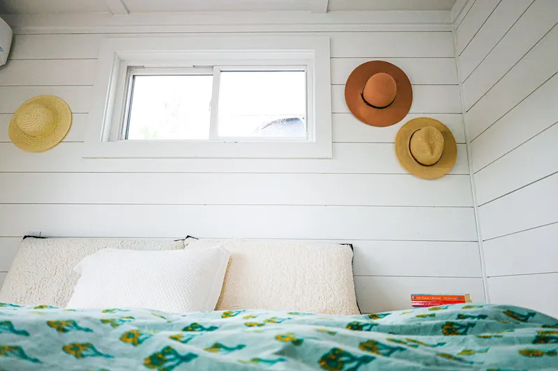  Yacht Photos Pics Cozy bedroom in Hank's 40 Houseboat, featuring hats on white shiplap walls, 2025 model.