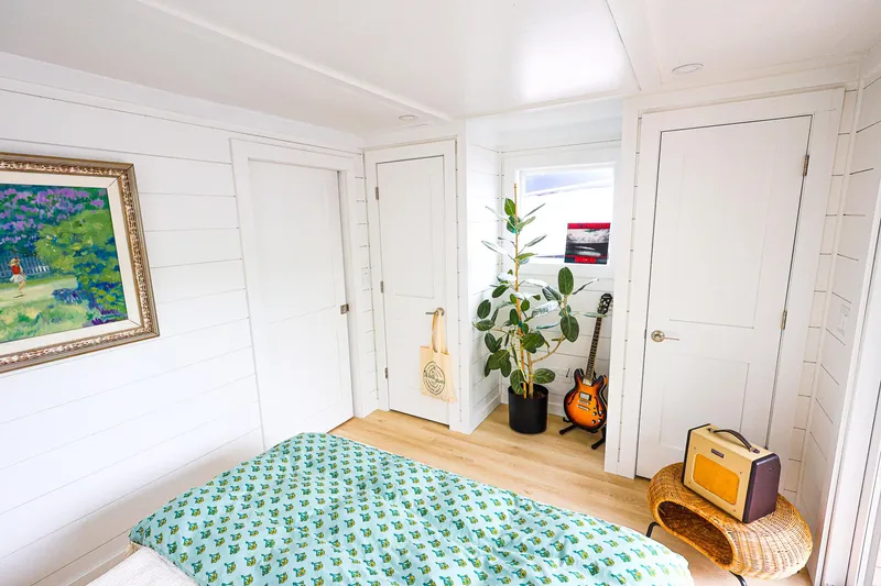  Yacht Photos Pics Cozy houseboat bedroom with guitar, plant, and vibrant decor, 2025 Hank's 40 model.