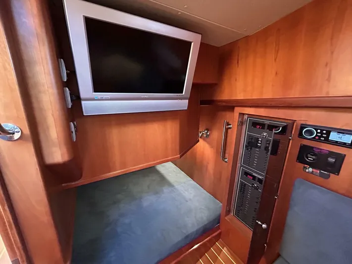 N'baluba Yacht Photos Pics 2008 Rivolta Coupe 4.5 interior with TV and control panel, featuring wood finish.