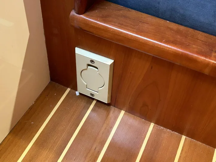 N'baluba Yacht Photos Pics Wooden interior of a 2008 Rivolta Coupe 4.5 with a wall-mounted outlet.