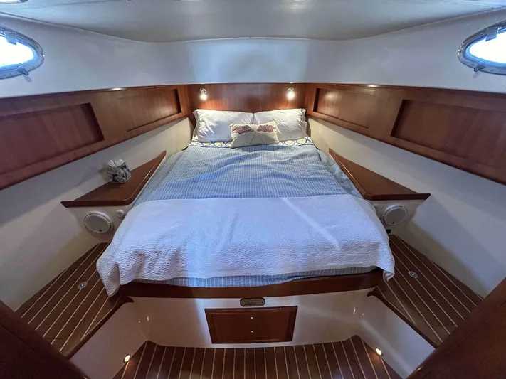 N'baluba Yacht Photos Pics Luxurious cabin interior of 2008 Rivolta Coupe 4.5 with cozy bed and wooden accents.