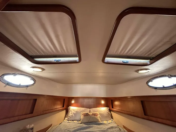 N'baluba Yacht Photos Pics Luxurious interior cabin of 2008 Rivolta Coupe 4.5 with cozy bed and skylights.