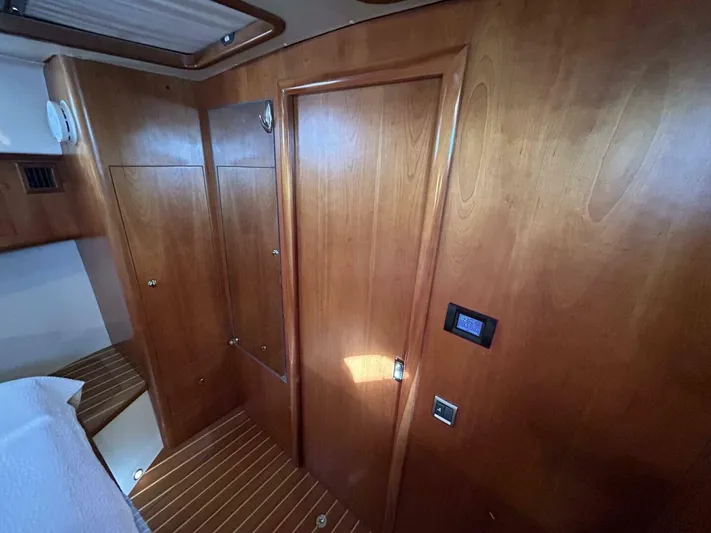 N'baluba Yacht Photos Pics Wood-paneled interior of 2008 Rivolta Coupe 4.5, featuring sleek design and modern finishes.