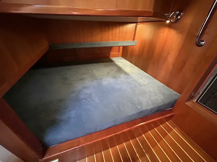 N'baluba Yacht Photos Pics 2008 Rivolta Coupe 4.5 interior cabin with wooden finish and cozy bed.