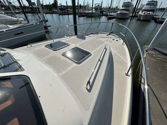 N'baluba Yacht Photos Pics 2008 Rivolta Coupe 4.5 yacht docked at marina, featuring sleek deck design.