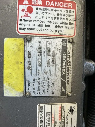 N'baluba Yacht Photos Pics Close-up of Yanmar engine label with warning signs and specifications.