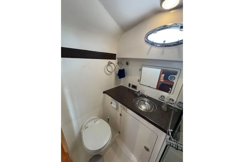 N'baluba Yacht Photos Pics 2008 Rivolta Coupe 4.5 bathroom interior with sink, toilet, and porthole window.