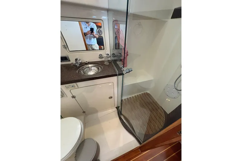 N'baluba Yacht Photos Pics Luxurious bathroom interior of 2008 Rivolta Coupe 4.5 with modern fixtures and glass shower.