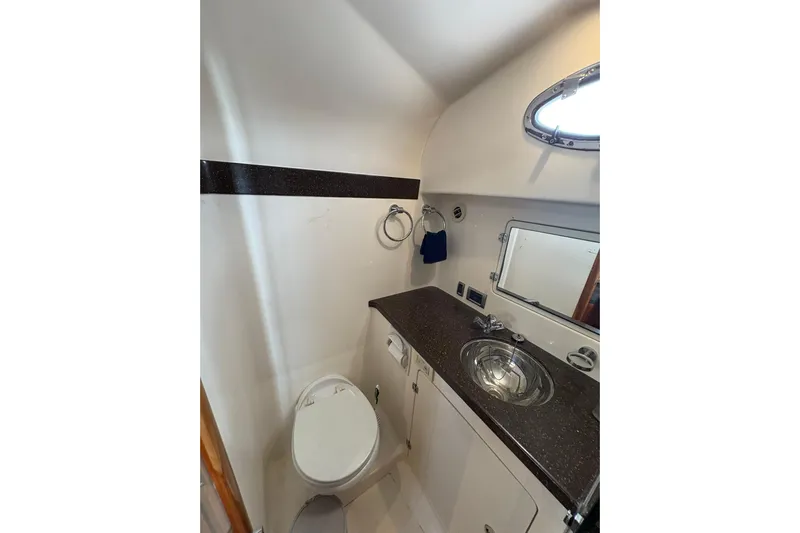 N'baluba Yacht Photos Pics 2008 Rivolta Coupe 4.5 bathroom interior with sink, toilet, and porthole window.