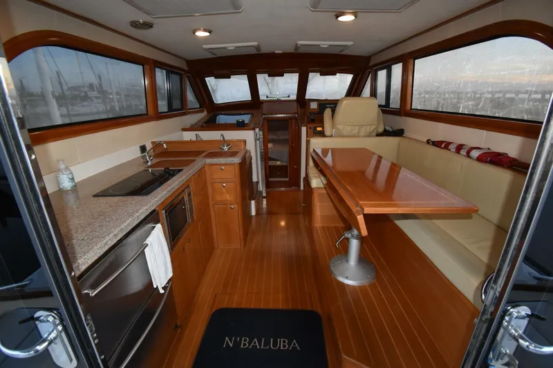 N'baluba Yacht Photos Pics Luxurious interior of 2008 Rivolta Coupe 4.5 yacht with kitchen and seating area.