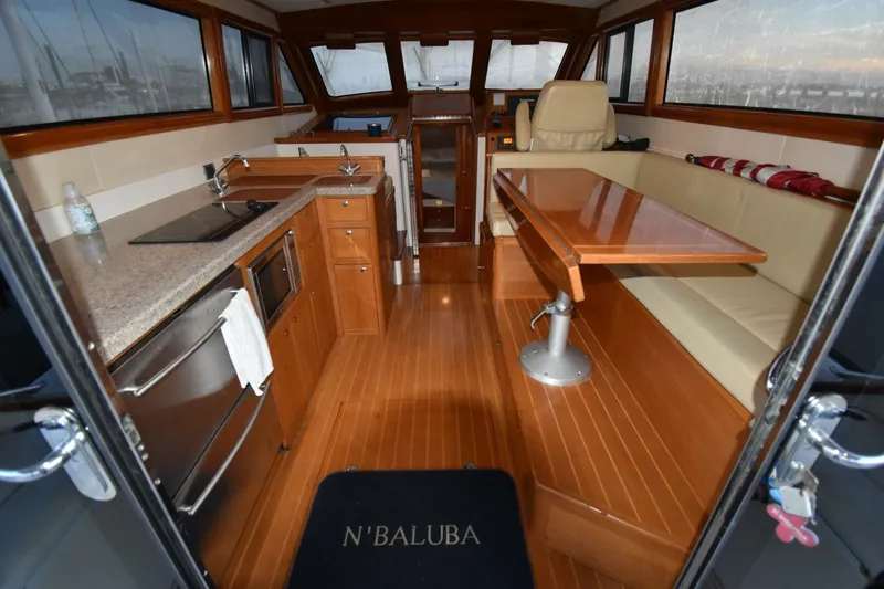 N'baluba Yacht Photos Pics Interior of 2008 Rivolta Coupe 4.5 yacht with kitchen and seating area.
