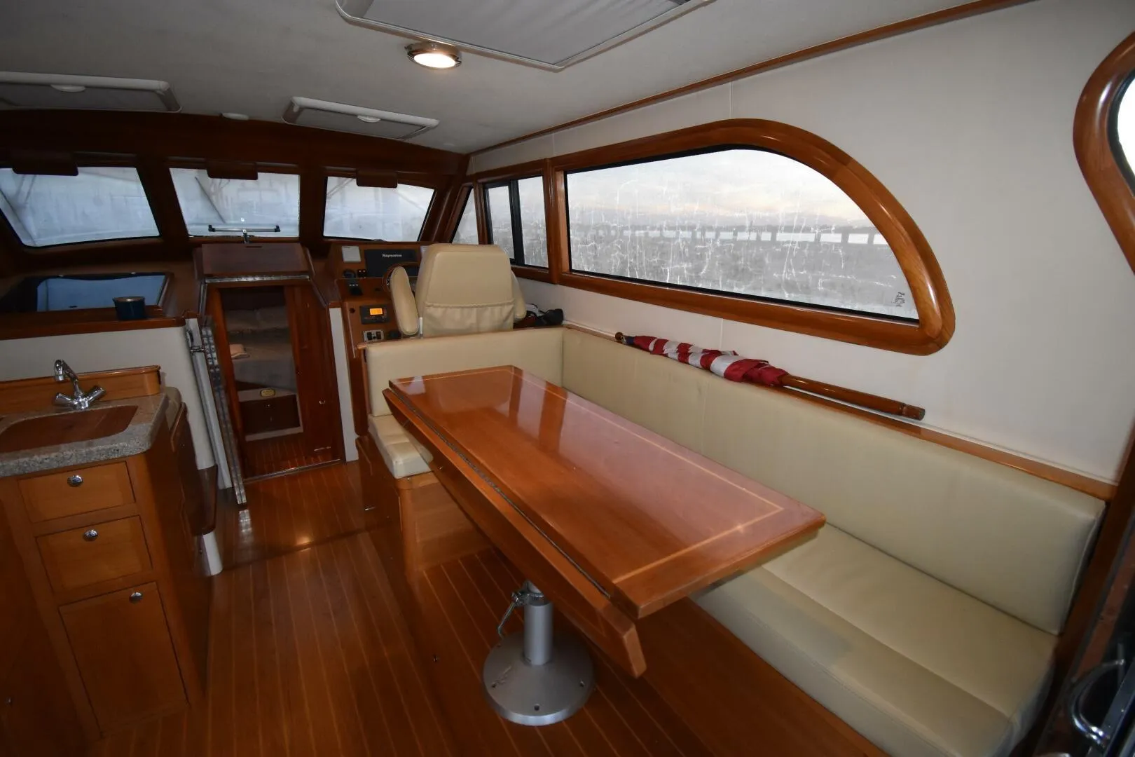 Luxurious interior of 2008 Rivolta Coupe 4.5 yacht with wooden furnishings and seating area.