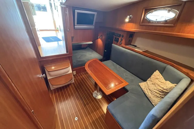 N'baluba Yacht Photos Pics Luxurious 2008 Rivolta Coupe 4.5 yacht interior with wood paneling and cozy seating area.