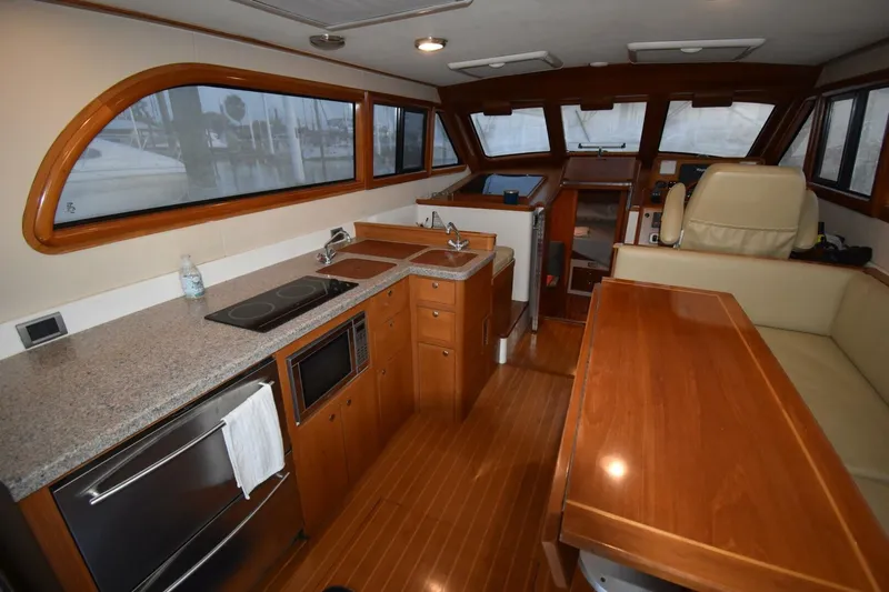 N'baluba Yacht Photos Pics Luxurious 2008 Rivolta Coupe 4.5 yacht interior with kitchen and seating area.
