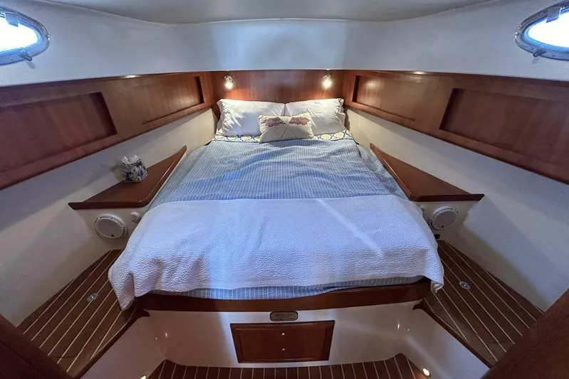 N'baluba Yacht Photos Pics Luxurious cabin interior of 2008 Rivolta Coupe 4.5 with cozy bed and wooden accents.