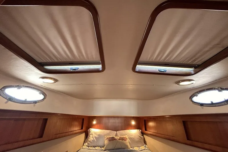 N'baluba Yacht Photos Pics Interior cabin of 2008 Rivolta Coupe 4.5 with skylights and cozy bedding.