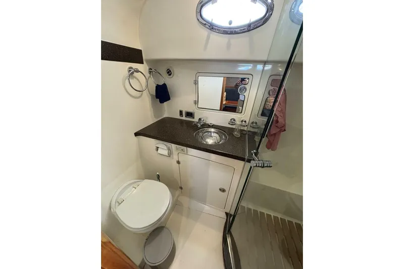 N'baluba Yacht Photos Pics Compact bathroom in a 2008 Rivolta Coupe 4.5, featuring a sink, toilet, and shower.