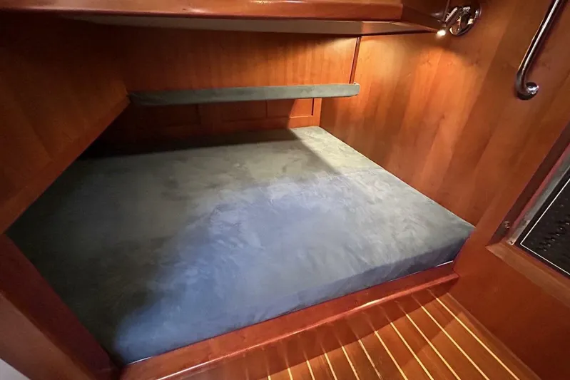 N'baluba Yacht Photos Pics 2008 Rivolta Coupe 4.5 interior cabin with wooden finish and cozy bed.