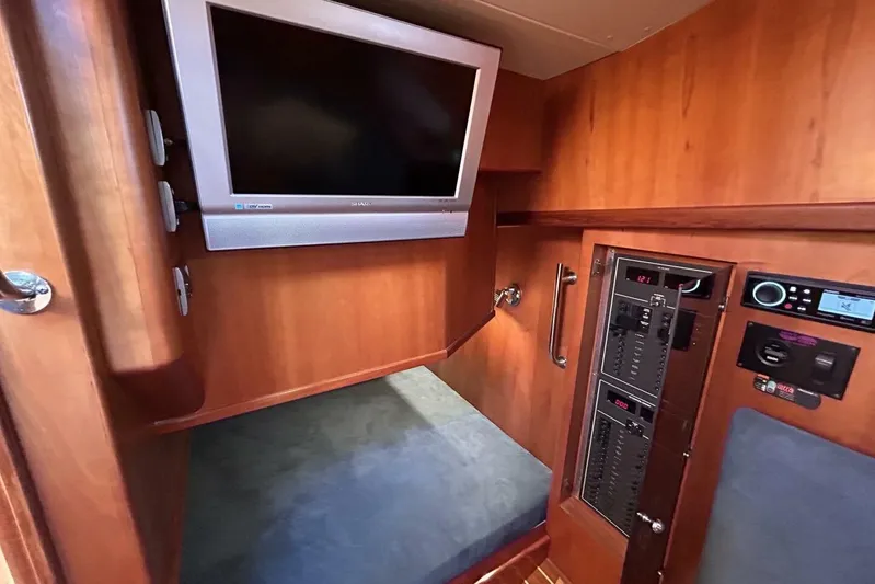 N'baluba Yacht Photos Pics 2008 Rivolta Coupe 4.5 interior with TV and control panel, featuring wood paneling.