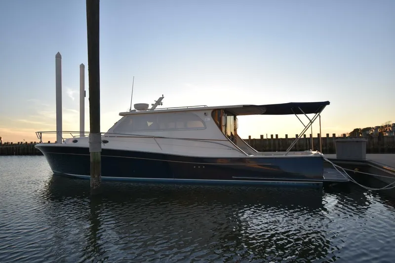 N'baluba Yacht Photos Pics 2008 Rivolta Coupe 4.5 yacht docked at sunset, featuring sleek design and elegant lines.