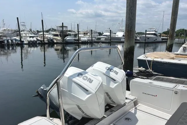  Yacht Photos Pics 2019 Axopar 28 boat with twin Mercury engines docked at a marina.
