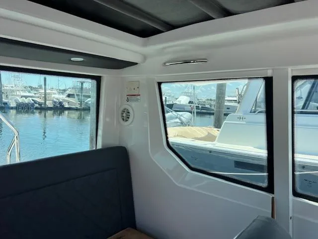  Yacht Photos Pics Interior view of 2019 Axopar 28 boat with marina in background.