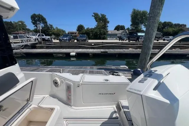  Yacht Photos Pics 2019 Axopar 28 boat docked at marina with clear blue sky.