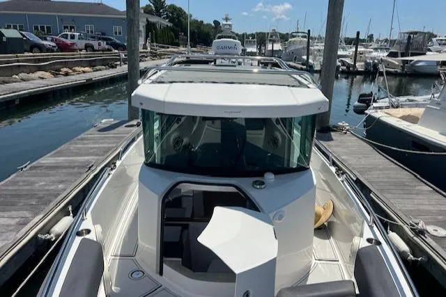  Yacht Photos Pics 2019 Axopar 28 boat docked at a marina, featuring sleek design and modern amenities.
