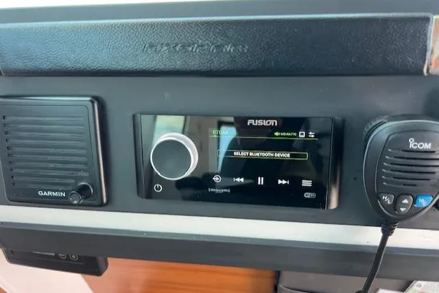  Yacht Photos Pics Control panel of a 2019 Axopar 28 boat featuring Garmin and Fusion audio systems.